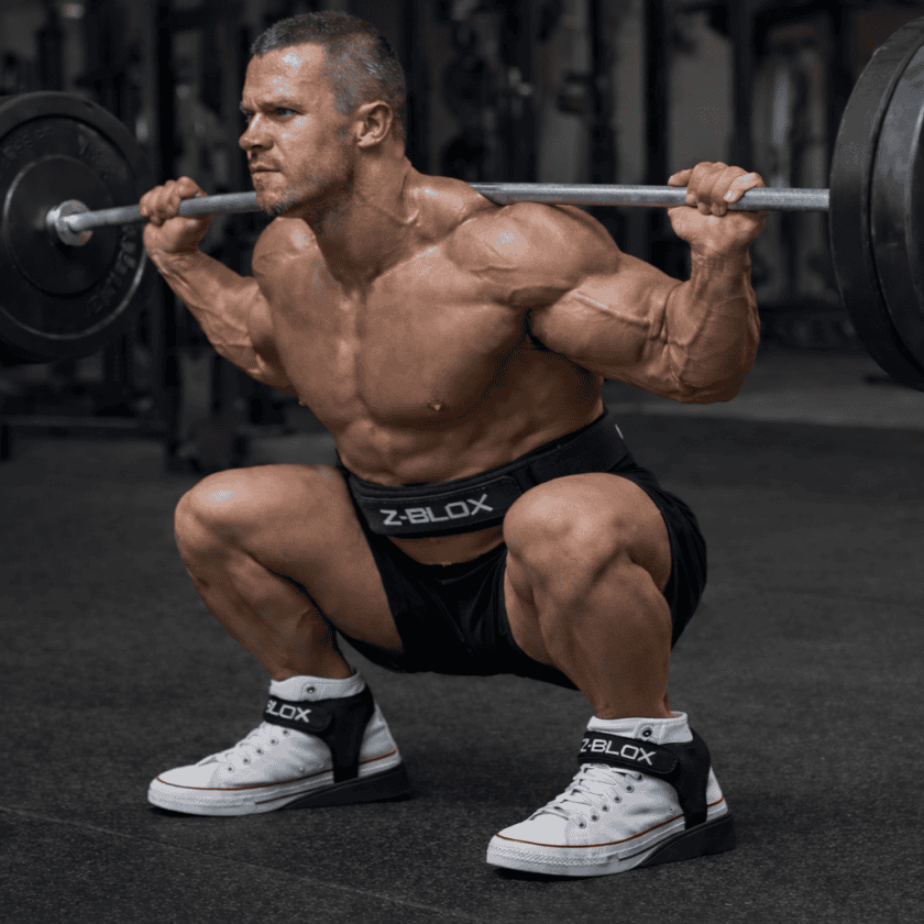 Athlete using Z-BLOX heel wedges to improve squat depth in gym